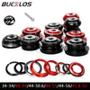 Set of black and red bicycle headset components including cups, stem, and bearing parts