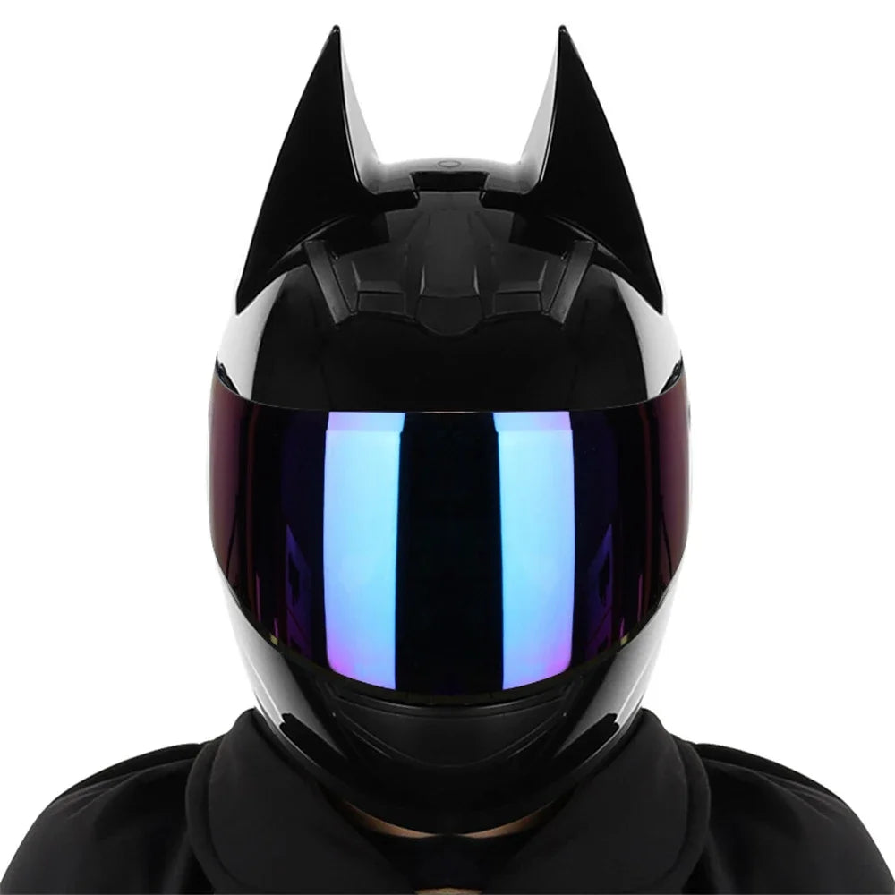 A black full face motorcycle helmet with a reflective blue visor and sharp horns.