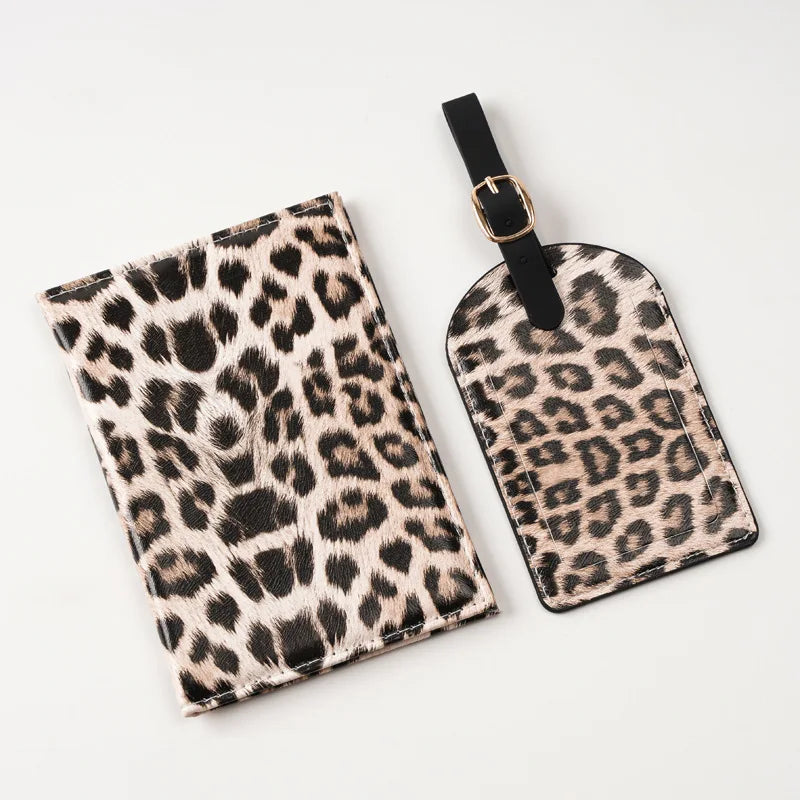 A black and beige leopard print passport holder with card slots attached to a black strap.