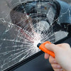 A hand uses an orange tool to break a spiderweb crack in a car window.