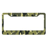 A rectangular license plate cover with a camouflage pattern featuring olive green and dark green leaves.
