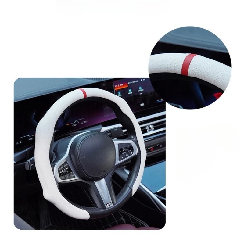 A close-up view of a white steering wheel cover with red accents on a car's interior.