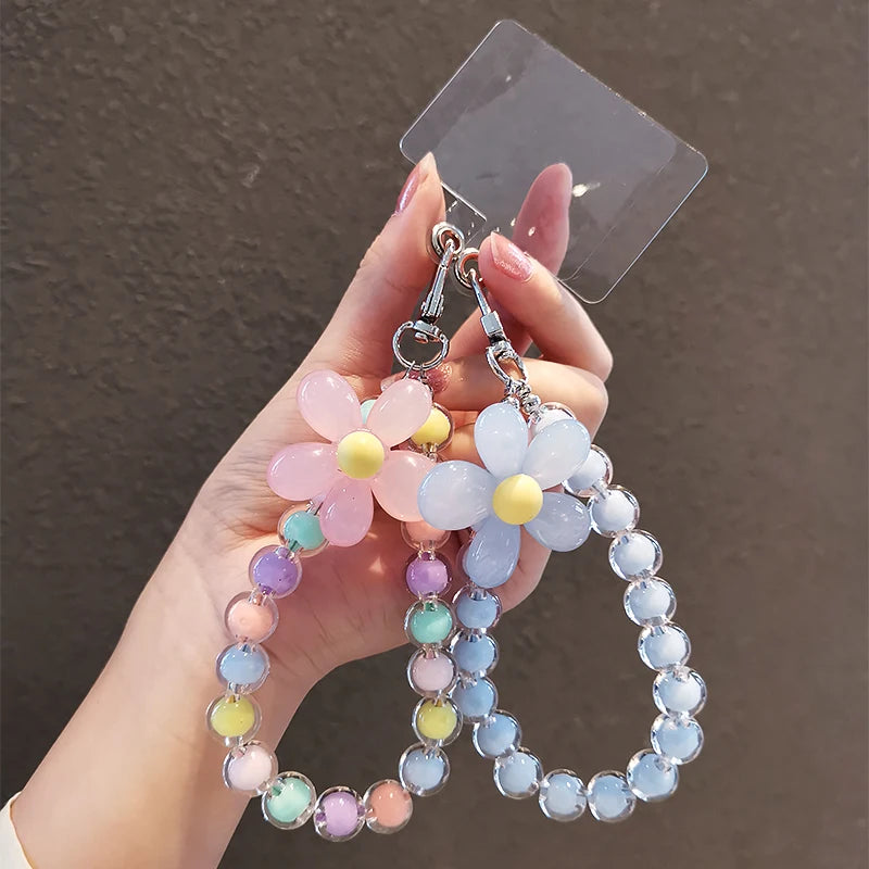A hand holds a phone anti-loss lanyard featuring round beads in shades of pink, purple, and blue.