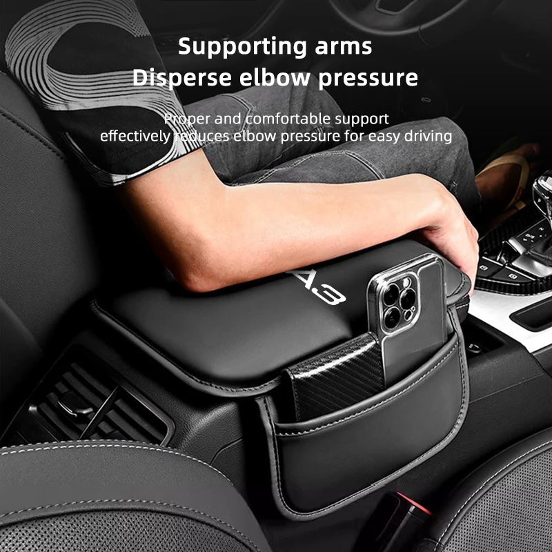 A hand rests on a black leather car armrest protector mat with storage pockets, designed to disperse elbow pressure.