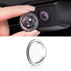 A close-up view of a car camera lens protected by a clear film, showing the lens and surrounding housing.