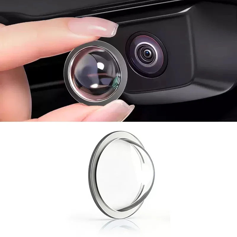 A close-up view of a car camera lens protected by a clear film, showing the lens and surrounding housing.