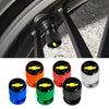 A set of durable aluminum tire valve covers in various colors including blue, orange, green, and black.