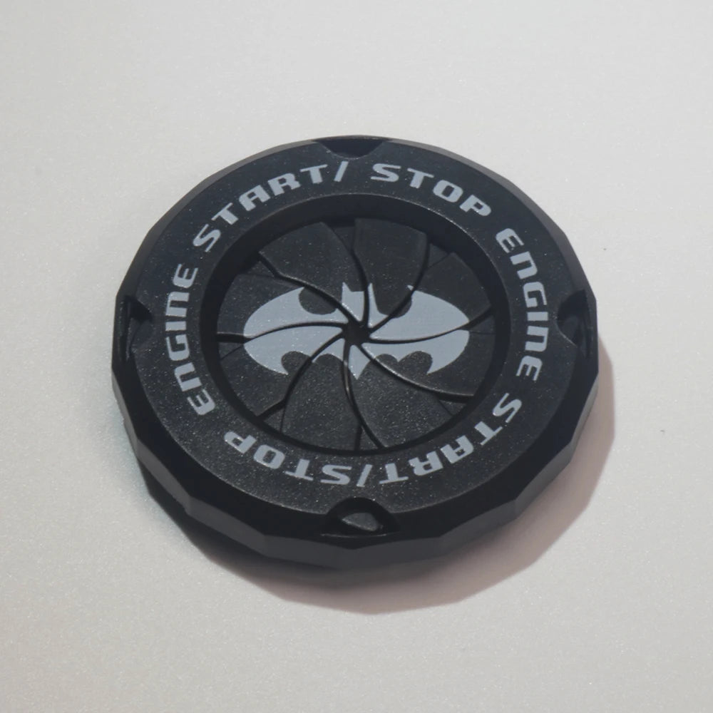 Black decorative car start button cover decal featuring a silver bat emblem.