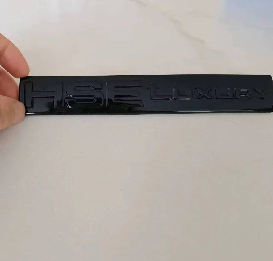 Black HSE Luxury car badge decal for Discovery 4 displayed on a white surface.