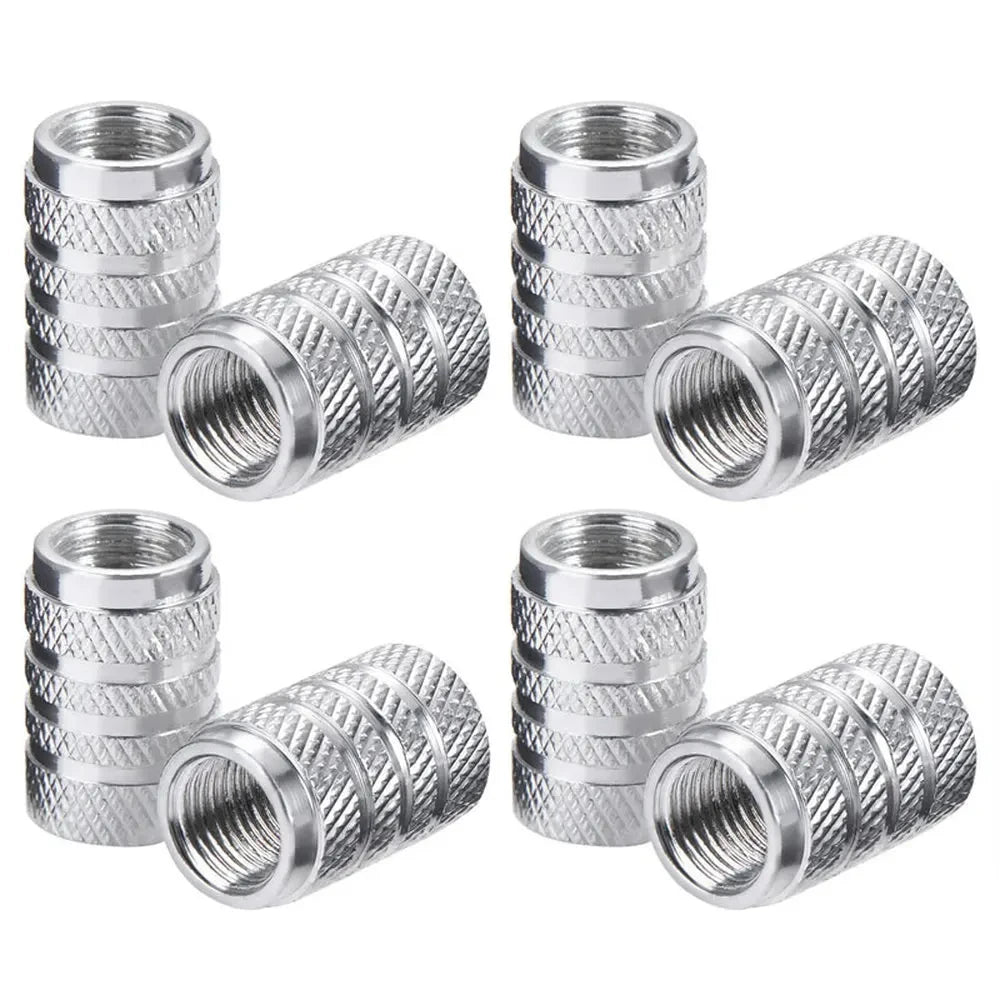 A set of silver aluminum tire valve caps with knurled texture.
