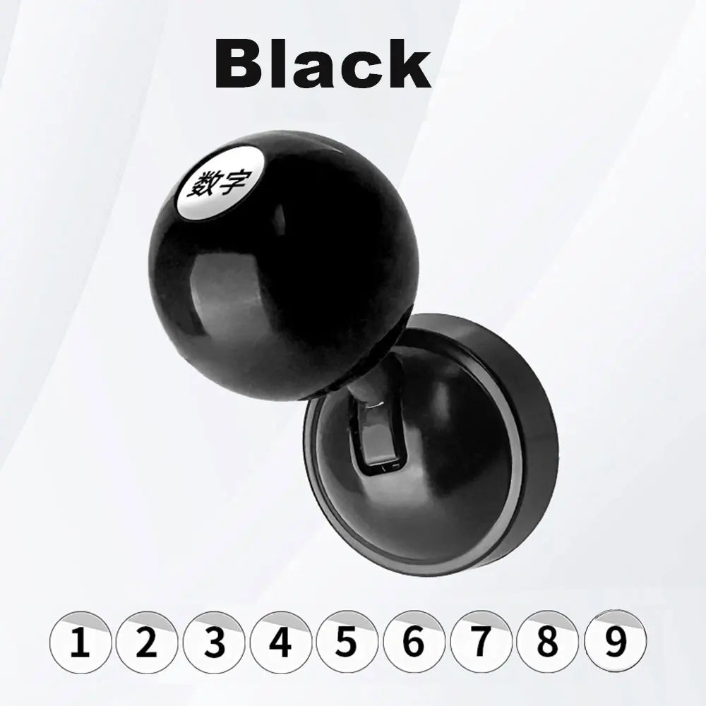 A black car start button cover with a lucky number engraved on the top.
