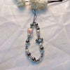 A silver and clear bead lanyard with a heart pendant is displayed against a white background.