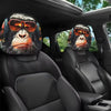 Two black gorilla headrest covers with orange sunglasses are shown inside a car seat.