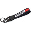 Cache du réservoir de liquide de frein de la moto R6 noir et rouge avec une boucle de porte-clés.