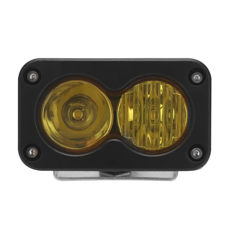 Black LED pod spotlight with dual amber lenses mounted for motorcycle offroad headlights