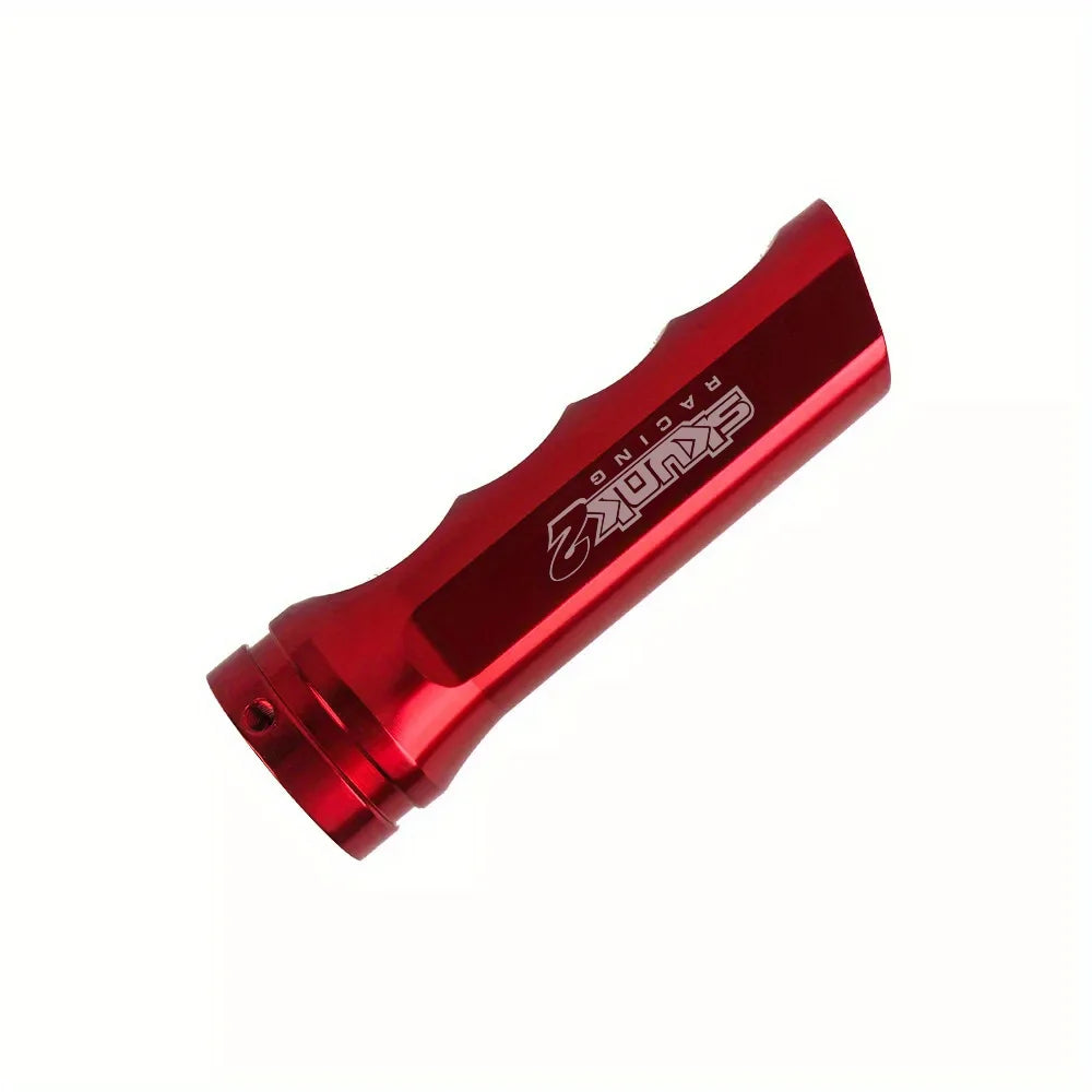 A red aluminum handbrake cover for a manual transmission.