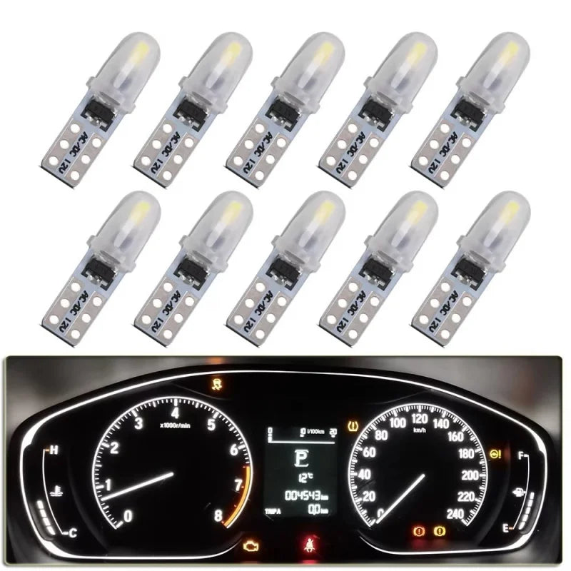 A set of T5 LED dashboard and license plate bulbs arranged in a row.