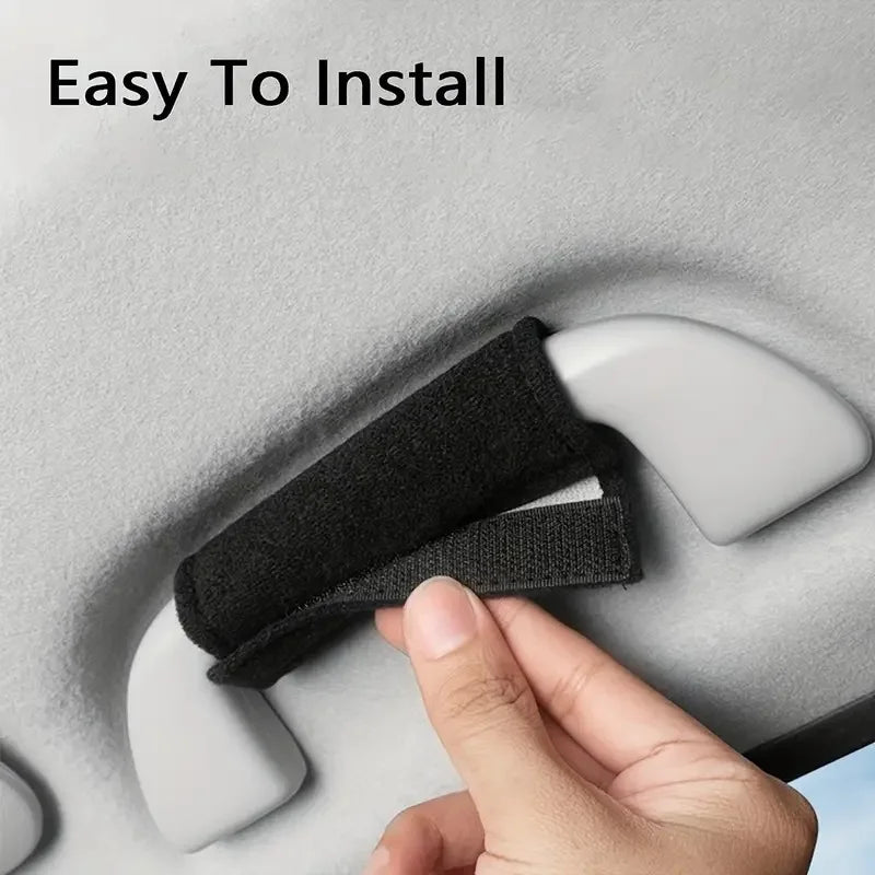 A hand is installing a black car handle cover onto a white car interior surface.