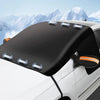 Black magnetic anti-frost windshield sunshade installed on a white car.