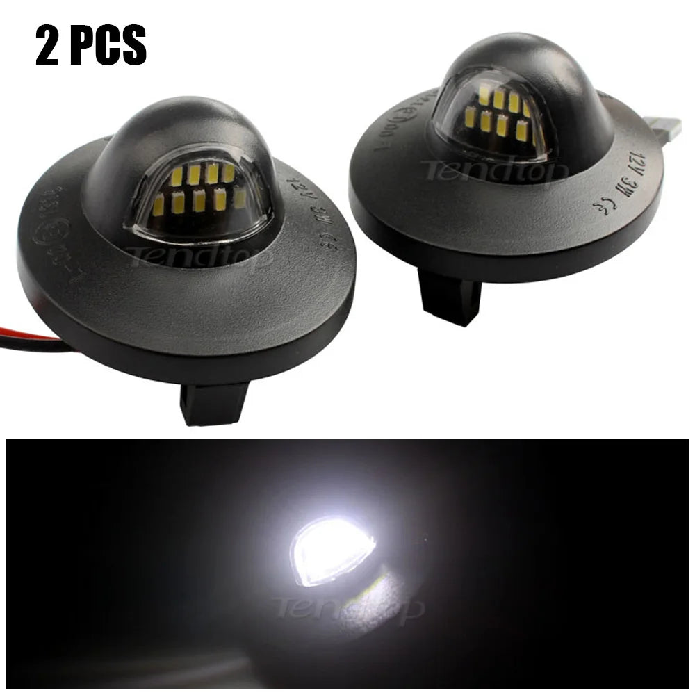 Two black LED license plate lights with yellow illumination are shown against a dark background.