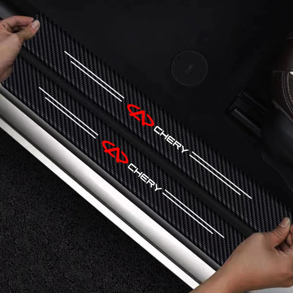 Black carbon fiber door sill protection stickers installed on a car door frame.