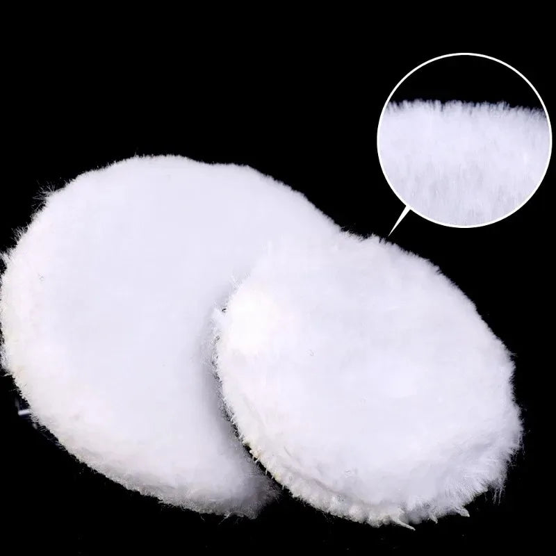 Two white polishing discs or pads are shown against a black background.