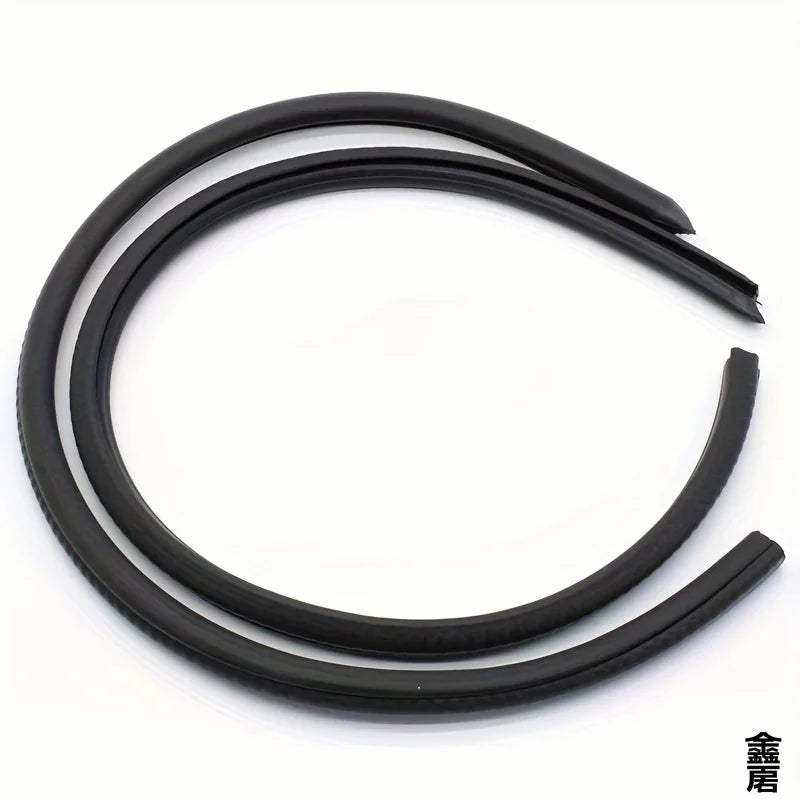 Black car door edge weatherstrip seal strips coiled on a white background