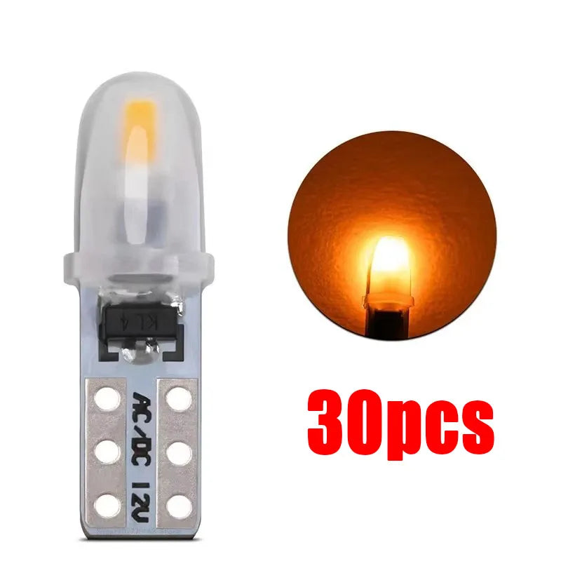A set of 30 T5 LED dashboard and license plate bulbs with silver bases and clear glass bulbs.