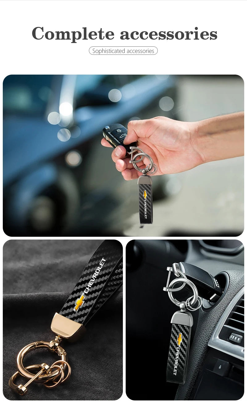 A close-up of a luxury metal keyring set featuring a black and gold patterned fob being held by a hand.