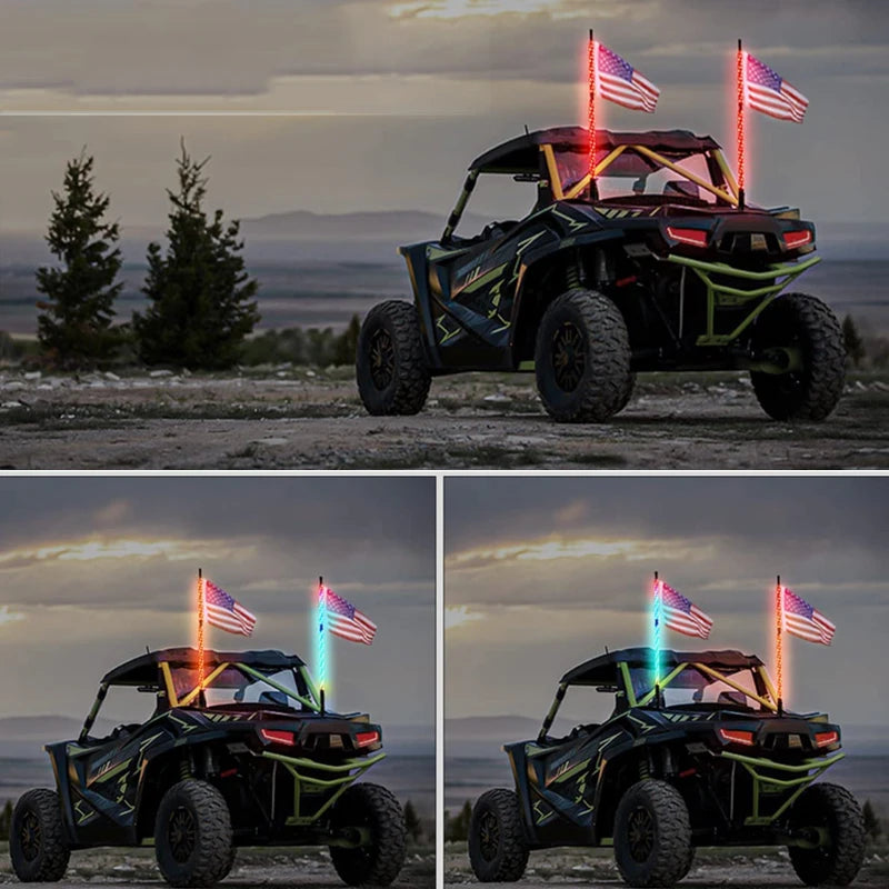 A black off-road vehicle with RGB chasing lights and American flags mounted on the roof against a sunset sky.