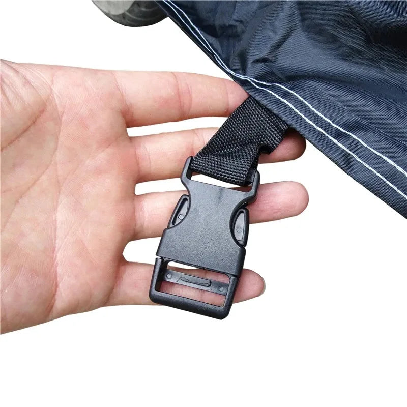 A hand is holding a black waterproof cover strap for an all-season motorcycle or scooter cover.