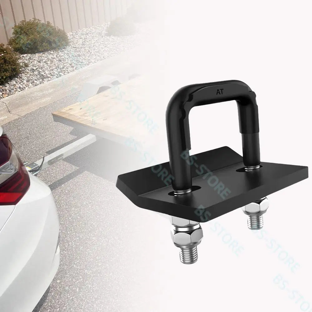 A black heavy duty trailer hitch clamp and isolator mounted on a vehicle's rear, shown in a close-up view.