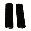 A pair of black luxury car seatbelt shoulder pads.