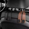 Black leather car headrest hooks with brown leather straps for bag organization