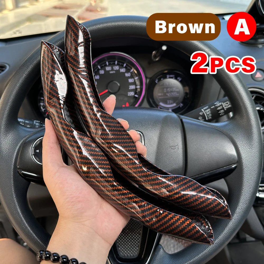 Brown leather steering wheel booster covers in a pair shown being held over a car steering wheel.