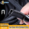 A hand holds a black car door anti-collision strip trim, showing its texture and shape.