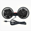A black car cooling fan with two circular blades and a flexible cord.
