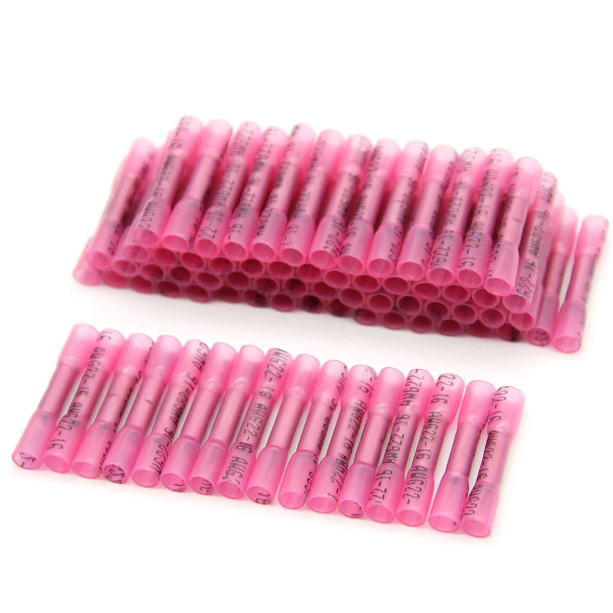 A row of pink durable heat shrink wire connectors arranged in a linear pattern.