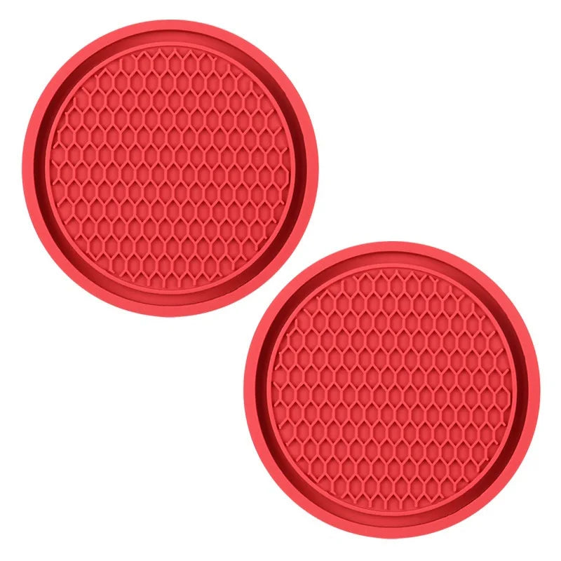 A set of red, hexagonal silicone coasters with a textured surface.