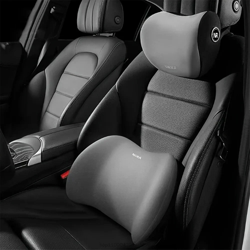 A close-up view of a black car seat with an installed gray headrest neck support pillow.