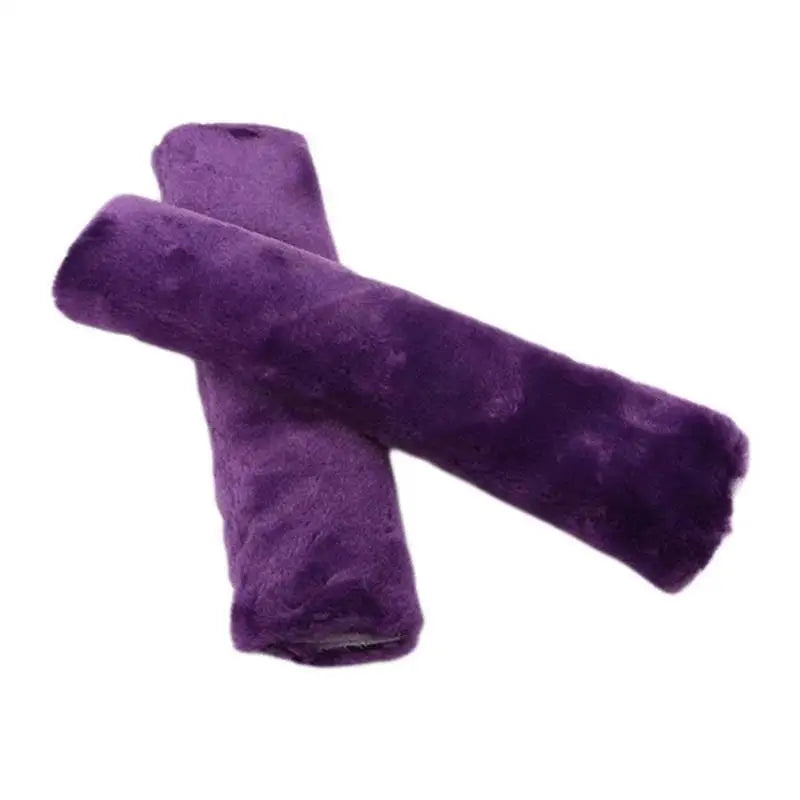 A purple luxury car seatbelt shoulder pad rolled into a cylindrical shape.