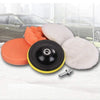 A kit of three foam polishing pads in orange, black, and white for professional car detailing.