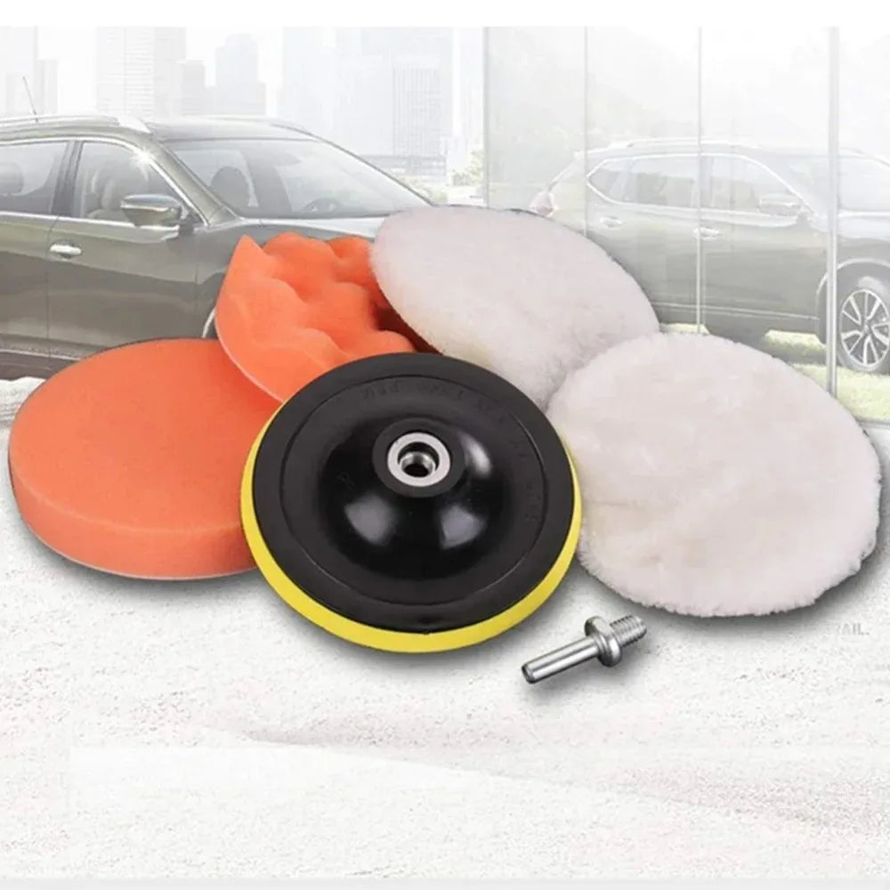A kit of three foam polishing pads in orange, black, and white for professional car detailing.