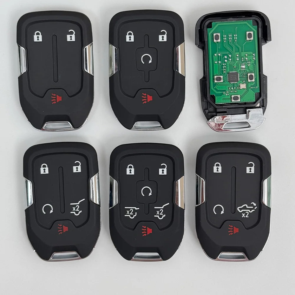 A set of aftermarket remote keys for Chevrolet trucks and SUVs, including black plastic key fobs and a green electronic modul