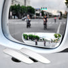 A convex angle car mirror reflecting a street scene and surrounding environment.