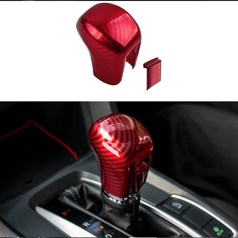 A close-up view of a red carbon fiber gear shifting knob cover for a Honda Civic.