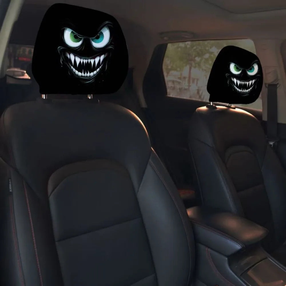 A pair of black horror themed car headrest covers featuring glowing green monster faces are shown in a car interior.
