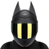 A black full face motorcycle helmet with a reflective yellow visor and sharp horns.