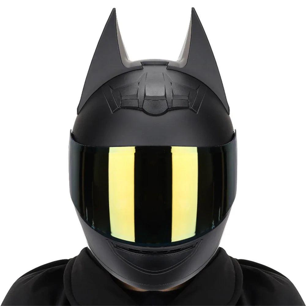 A black full face motorcycle helmet with a reflective yellow visor and sharp horns.