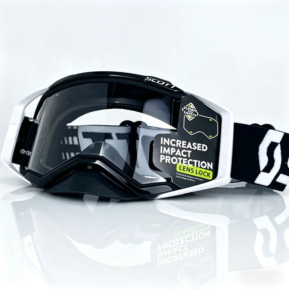 A pair of black and white safety goggles with a lens lock feature resting on a reflective surface.